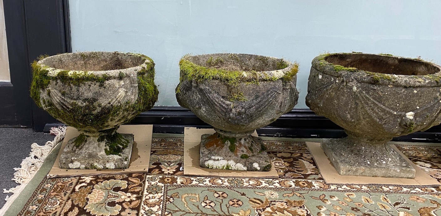 Two pairs of circular reconstituted stone garden planters, larger diameter 39cm, height 33cm